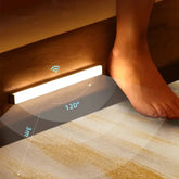Wireless motion sensor smart LED night light strip mounted under furniture for home illumination